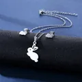 Macro detail of silver rabbit necklace and earrings set on a dark textured display - Rabbit with Ear Profile Style (TZ-90)
