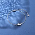 Detailed macro of a stainless steel bracelet featuring hollow interlocking hearts - Triple Heart Style (XLY31 Steel)