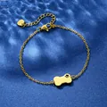 Golden stainless steel bone pendant bracelet with heart paw cutout on a blue background - Bone Paw Print Style (XLJ105)