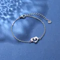 Macro shot of silver stainless steel chain bracelet featuring a hollow dolphin charm - Dolphin Style (XLY34 Steel)
