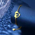 Gold dolphin heart charm bracelet in stainless steel on blue water ripple background - Double Dolphin Heart Style (XLJ124)