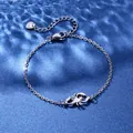Macro view of silver scorpion pendant with lobster clasp and heart tag on water ripple background - Scorpion Style (XLY108)