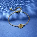 Detail of gold stainless steel bracelet with spiral motif on blue water-ripple background - Spiral Vortex Style (XLJ117)