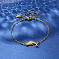 Detailed close-up of a golden dolphin pendant on a stainless steel chain on blue water waves - Dolphin Shape Style (XLJ118)
