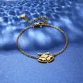 Close-up of gold stainless steel bracelet with double Christmas bell pendants - Christmas Bells Style (XLJ121)
