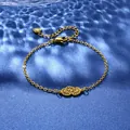 Detail of gold floral charm bracelet with dual cutout daisies and heart pendant - Double Flower Hollow Style (XLJ123)
