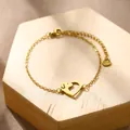 Golden heart-shaped dog paw bracelet with adjustable extension chain on wooden base - Heart Dog (XLJ184)
