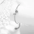 Silver stainless steel bracelet with an intricate openwork tulip flower pendant - February