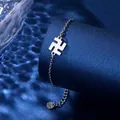 Close-up of stainless steel chain bracelet featuring a polished manji symbol charm - Swastika Style (XLY126)