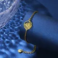 Detailed view of golden leaf pendant bracelet on blue display with water shadows - Round Hollow Leaf Style (XLJ133)