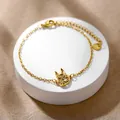 Detailed macro view of a golden stainless steel link bracelet with hollow animal charm - Hollow Animal (XLJ177)