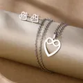 Polished stainless steel heart jewelry set with necklace and stud earrings on gold display - Infinity Symbol Heart (TZ-492)