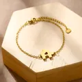 Detailed view of golden stainless steel jigsaw puzzle charm bracelet with heart cutout - Puzzle Heart (XLJ187)