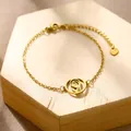 Detail of gold stainless steel bracelet with Virgin Mary pendant and heart charm - Virgin Mary Praying (XLJ189)