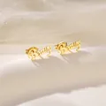 Minimalist gold Beauty script stud earrings with butterfly back on stone background - Beauty Artistic Letters (SD8)