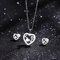 Macro view of silver heart jewelry set with LOVE engraving on sparkling black background - LOVE Hollow Heart Style (TZ-409)