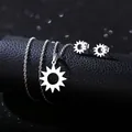 Close-up of silver stainless steel sunburst necklace and earring set on black leather - Hollow Sun Style (TZ-429)