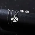 Detailed view of stainless steel lotus necklace and earrings set on black leather - Lotus Style (TZ-433)