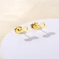 Detail of gold infinity heartbeat stud earrings on a round white display pedestal - Infinity and EKG Shape (SD17)