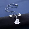 Macro shot of silver heart-shaped necklace and earrings with LOVE engraving detail - LOVE Heart Style (TZ-109)