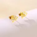 Macro shot of gold-plated double hollow heart earrings with polished finish on white surface - Double Overlapping Hearts (SD35)