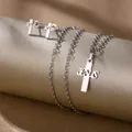 Macro view of silver stainless steel cross jewelry set with JESUS engraved details - Jesus Cross (TZ-481)