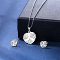 Macro shot of silver stainless steel heart necklace and earrings set with volleyball texture - Volleyball Heart Style (TZ-132)