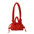 Vibrant red puffer tote bag with puffy quilted texture and knot handle detail - Red