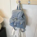 Vintage light blue denim backpack with classic flap cover and front metal buckle pockets - Light Blue