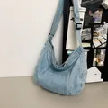 Detail of light blue denim crescent bag with adjustable wide strap for casual wear - Light Blue