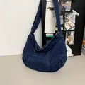 Detail of dark blue denim tote bag showing patchwork design and adjustable wide strap - Dark Blue