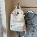 Quilted puffer backpack in pearl white metallic finish with black zipper details - Off White