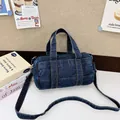 Dark blue denim cylinder handbag with yellow stitching and adjustable strap - Dark Blue