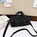 Dark grey denim cylinder tote bag with contrast stitching and shoulder strap - Black