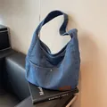 Denim blue large Hobo shoulder bag with washed texture and brown leather label accent - Dark Blue