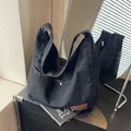 Black denim tote bag with orange stitching and spacious design for daily commute - Black