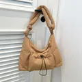 Brown puffy padded shoulder bag with knotted strap and drawstring front pocket - Brown
