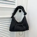 Black quilted puffer shoulder bag with a drawstring pocket and knotted wide strap - Black