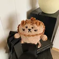 Handmade crochet lion protective case for wireless earbuds in warm brown yarn tones - Little Lion
