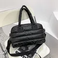 Quilted black puffer tote bag with detachable shoulder strap and padded top handles - Black