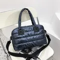 Deep blue quilted puffer tote bag with detachable woven shoulder strap and glossy finish - Blue