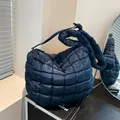Quilted navy blue puffy hobo bag with wide padded shoulder strap and soft textile finish - Dark Blue