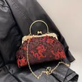 Vintage Chinese embroidered evening bag featuring red dragon motifs and gold handle - Black