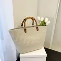 Large cream woven straw tote bag with retro bamboo top handle for summer beach vacation - Off White