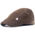 Detail of adjustable metal buckle and side embroidery on brown cotton newsboy cap - Adjustable / Coffee