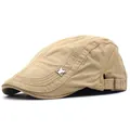 Detail of adjustable metal buckle and eagle badge on khaki cotton flat cap side - Adjustable / Khaki