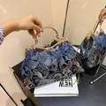 Blue retro shell bag with floral embroidery, gold chain strap, and rhinestone handle - Blue