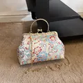 Floral embroidery vintage handbag with gold metal frame and pearl clasp detail - Silver