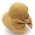 Detail of a natural raffia sun hat featuring a large elegant bow and fine woven texture - M (56-58cm) / Khaki