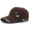 Detail view of cotton baseball cap featuring GSIOR embroidery and metal maple leaf badge - Adjustable / Coffee